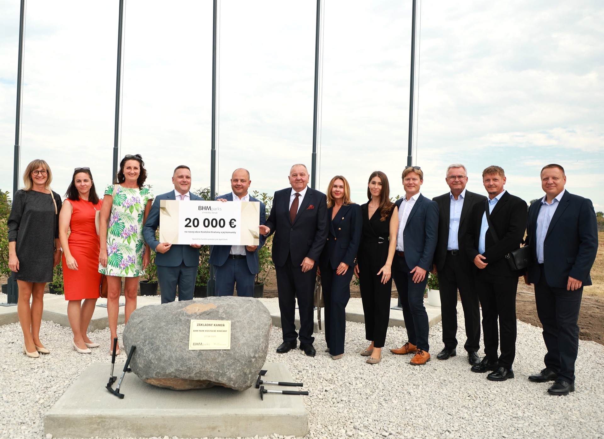 A generous donation of 20000 EUR being handed to the major of Kostolne Kracany to support community and development projects